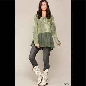 Tie dye knit and solid woven mixed  top with ruffle hem.